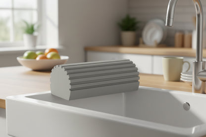 Rectangular grey 
plastic component on a kitchen sink

